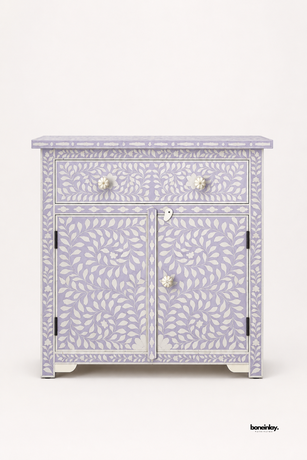 Handmade bone inlay storage cabinet in lavender with white leaf vine inlay, one drawer and two-door cupboard with bone flower knobs, photographed on a clean white background.