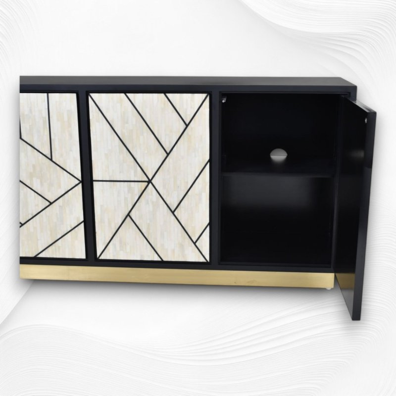 Handmade ivory bone inlay three-door credenza cabinet with open right door revealing interior storage shelf, bold geometric pattern doors, gold base, black mango wood body.