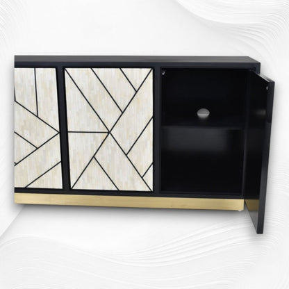 Handmade ivory bone inlay three-door credenza cabinet with open right door revealing interior storage shelf, bold geometric pattern doors, gold base, black mango wood body.
