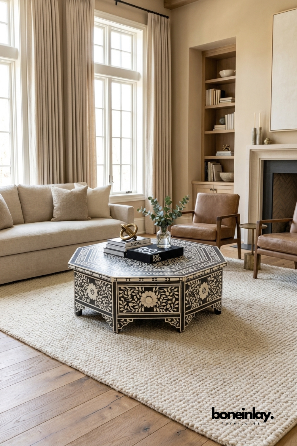 Handmade black and white floral bone inlay octagonal coffee table with drawers, styled in a neutral beige living room with sofa and armchair