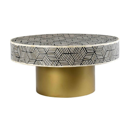 Handmade round bone inlay coffee table featuring black and white geometric cube inlay pattern with cylindrical gold brass base on white background