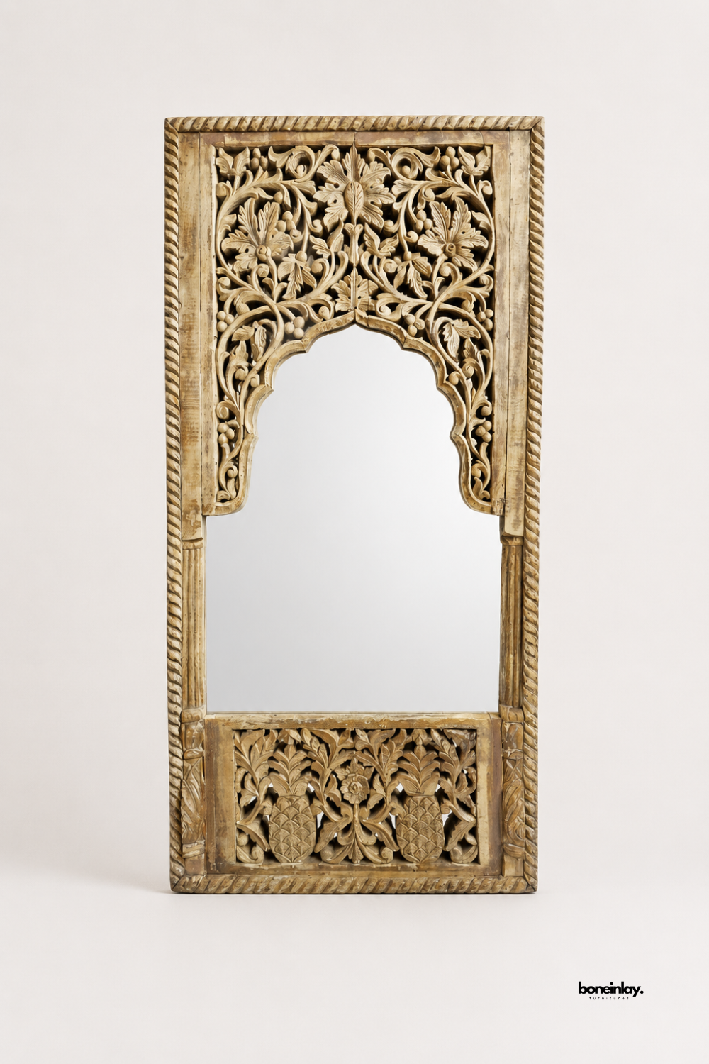 Artisan-crafted solid wood floor mirror showcasing an intricate scalloped arch crown with detailed floral scrollwork, a rope-carved outer border, and a carved pineapple motif bottom panel. Displayed on a clean studio background, this vintage Indian Jharokha statement mirror delivers rustic charm and architectural luxury for modern interiors.