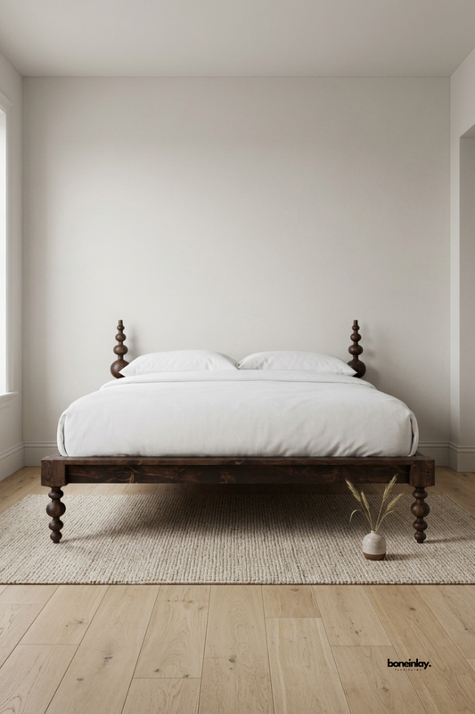 Handmade dark walnut wooden platform bed featuring turned bobbin spindle posts and crisp white bedding. Styled on a textured beige area rug in a sunlit minimalist bedroom, this artisan bed frame brings rustic warmth, timeless craftsmanship, and understated luxury to modern interiors.
