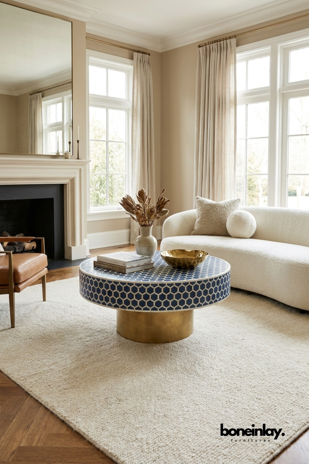 Navy blue hexagonal bone inlay round coffee table with polished brass base styled in a modern living room – handcrafted artisan furniture