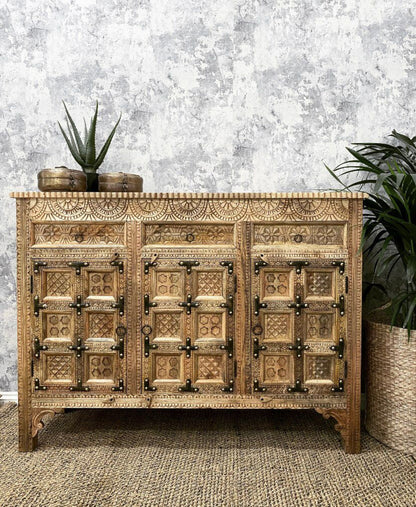Hand-carved solid wood Indian 3-door sideboard buffet with antique iron straps and sunburst carvings in natural warm wood finish.