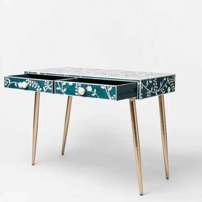 Handmade teal bone inlay desk with both drawers open showing storage interior, white floral vine pattern across top surface and drawer fronts, carved flower knobs, and brass tapered legs on white background