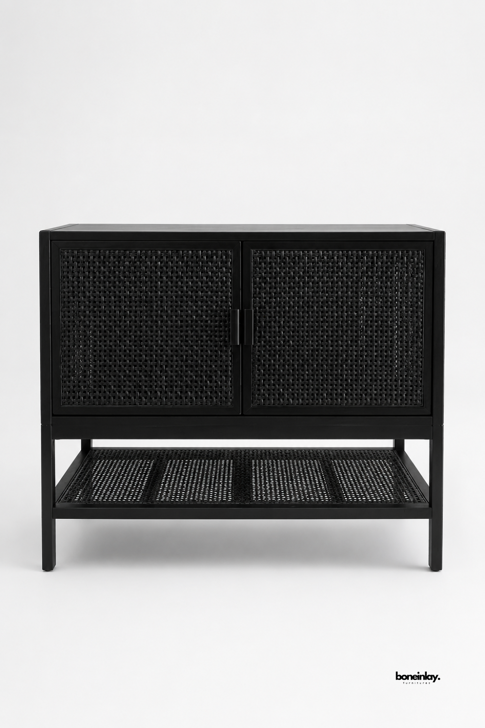 Artisan-crafted modern cabinet finished in sleek matte black with woven natural cane door fronts and an open bottom slatted cane storage shelf. Presented on a neutral studio background, this contemporary 2-door credenza seamlessly balances modern contrast with organic bohemian texture for living rooms, hallways, and dining areas.