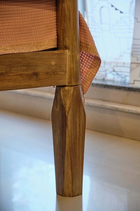 Handmade four-poster bed featuring carved leg