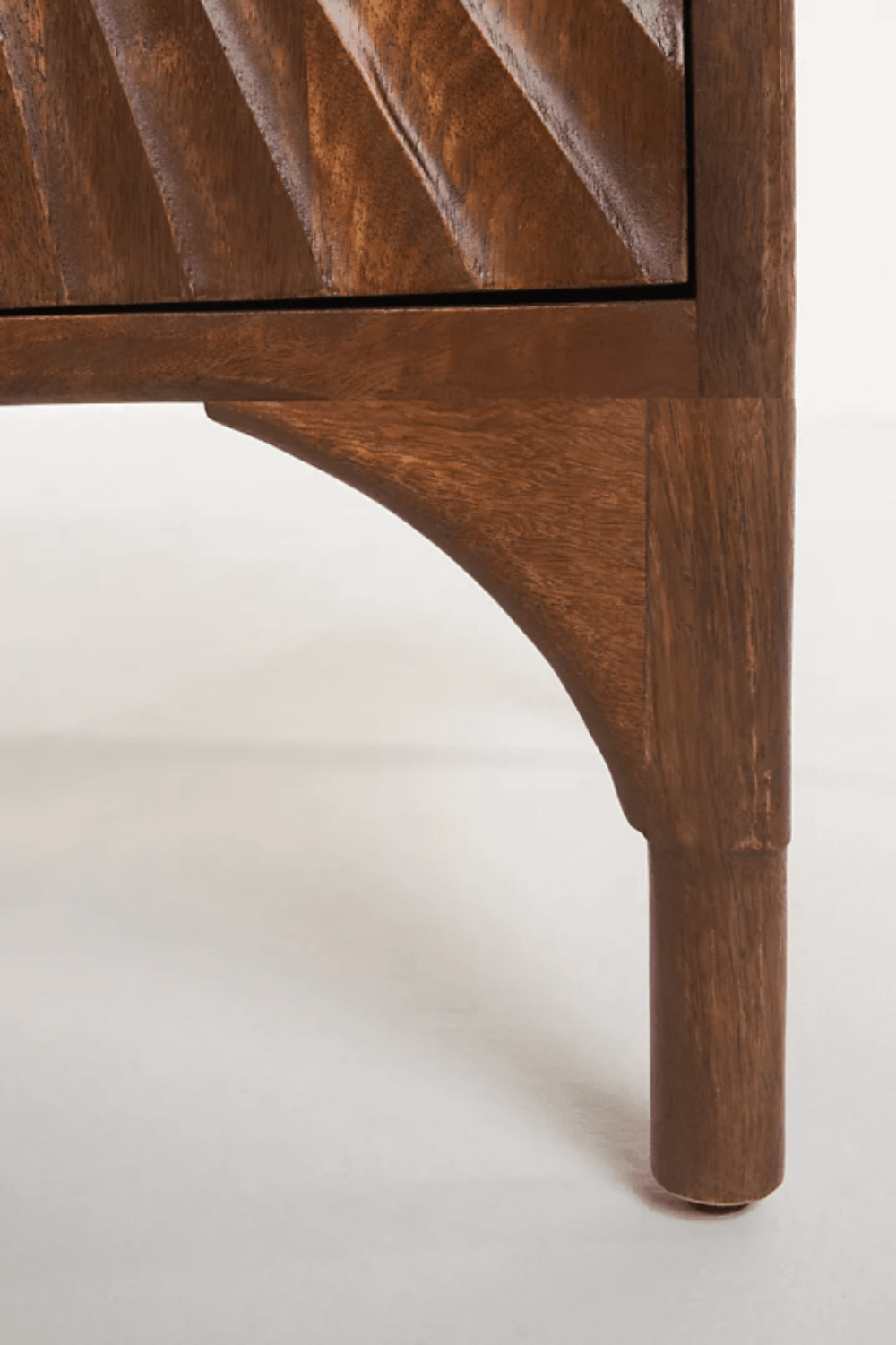Hardwood Work Desk in brown, close-up of leg showing the tapered support and carved detail at the lower corner.