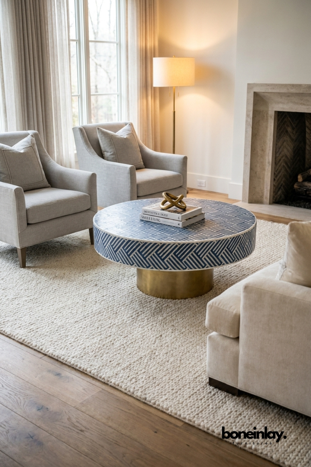 Herringbone bone inlay round coffee table with brass pedestal base styled in a modern luxury living room – navy blue and white handcrafted artisan piece