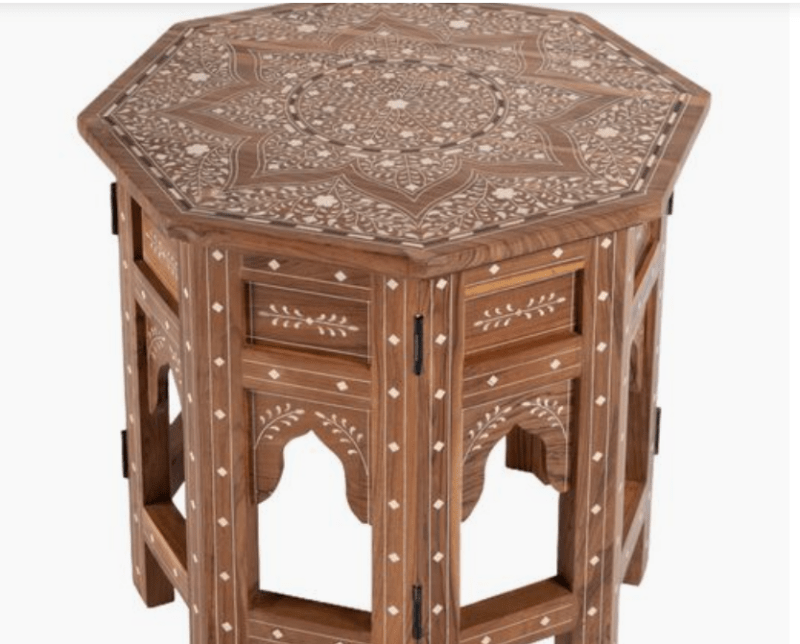Angled top view of Hexagonal Bone Inlay Teak Wood Accent Side Table showcasing intricate white bone inlay star and floral pattern on the tabletop with Mughal arch detailing on the teak wood base.