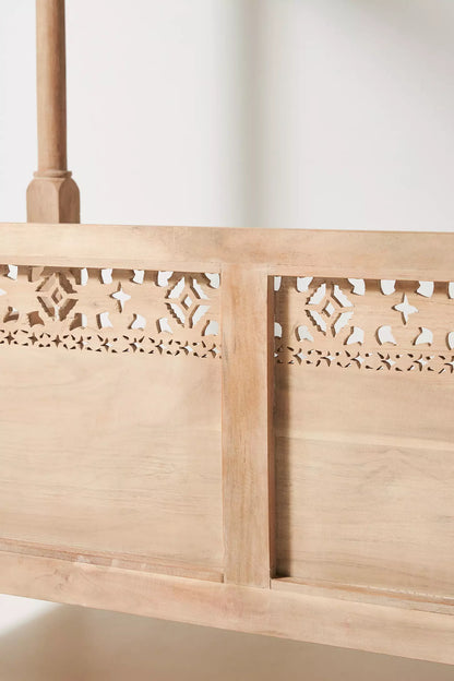 Indian-inspired wooden canopy diwan with intricate lattice backrest and natural timber finish.