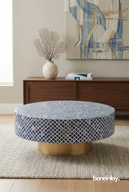 Indigo blue lattice bone inlay round coffee table with gold brass plinth base styled in a modern living room with vase and wall art