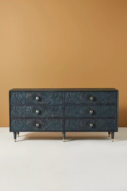 Full view of the indigo Gulliver six-drawer chest against a plain background, showing its carved drawer fronts.