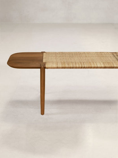 Inoda+Sveje-inspired teak and cane bench for indoor or outdoor seating in a warm natural finish.