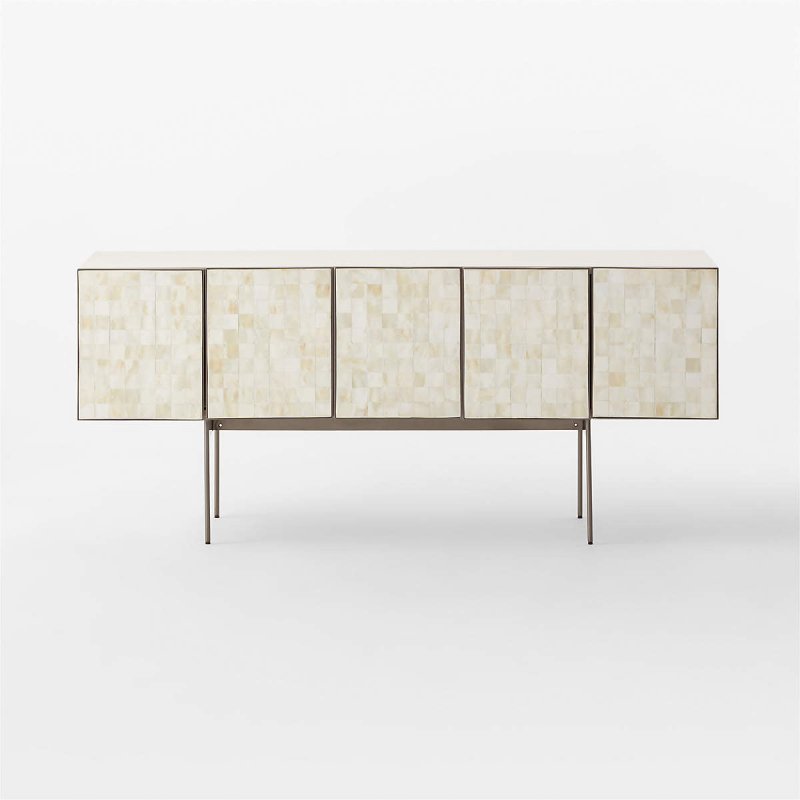 Ivory bone inlay media cabinet with five-panel carreau tile doors and slender gunmetal legs. Slightly angled view showing the depth, ivory top surface, and structured frame of the handcrafted entertainment unit. Minimalist background highlighting the clean lines and neutral palette of the storage console.