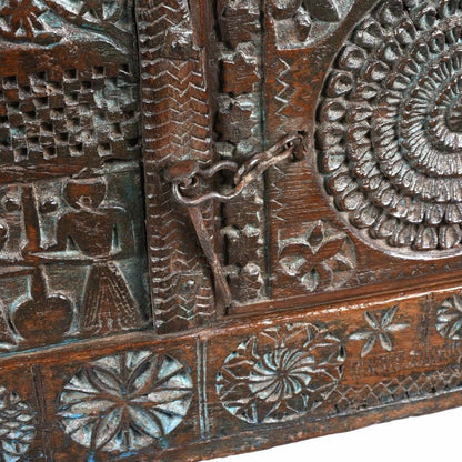 Latched wood blanket chest in natural walnut finish, front view close-up of the metal latch beside the carved rosette.