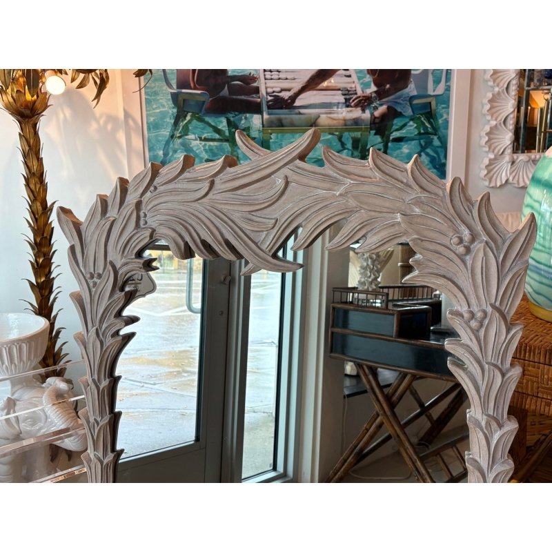 Leaf crest accent mirror in rustic solid wood, edge detail view showing the sweeping carved crown and upper frame.