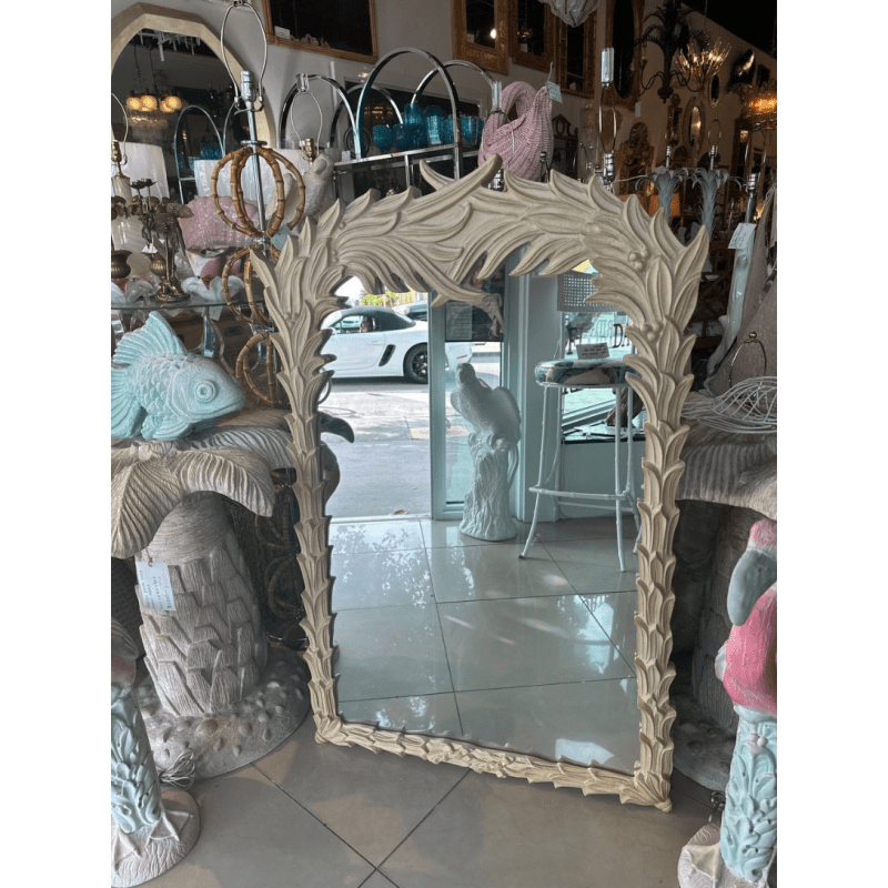 Leaf frame decorative mirror in rustic carved wood, front view with a tiled floor and doorway reflected in the glass.