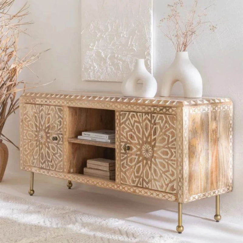 Albaron light wood media cabinet with open shelving and closed storage, styled in a living room with decor on top.