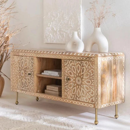 Albaron light wood media cabinet with open shelving and closed storage, styled in a living room with decor on top.