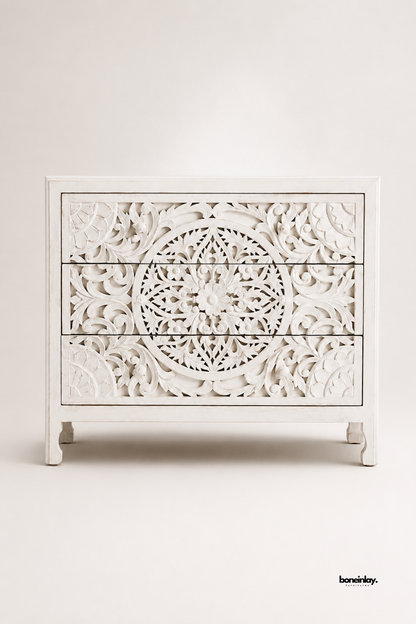 Whitewashed solid wood chest of drawers featuring an intricately hand-carved mandala and floral lattice design on the front panel. Includes three spacious drawers with a distressed antique-white finish and short curved legs. A boho-chic accent piece ideal for bedrooms, hallways, or living rooms. Combines artisanal craftsmanship with timeless farmhouse style.