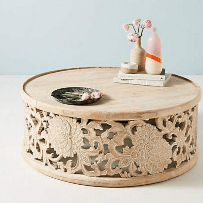 Lotus carved occasional table in light natural wood, front view showing a broad round top with floral decor.