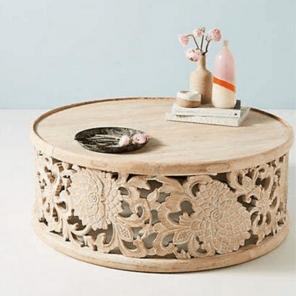 Lotus carved occasional table in light natural wood, front view showing a broad round top with floral decor.