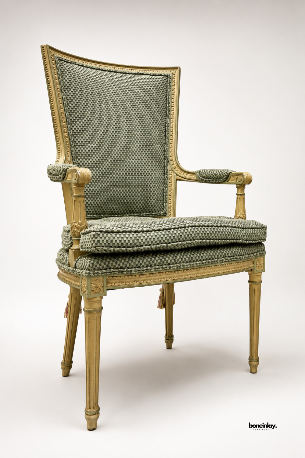 Vintage-style gilded wood armchair upholstered in a woven sage-green fabric with tasseled accents. Features hand-carved fluted legs, scroll armrests, and a tall tailored backrest for classic French-inspired appeal. A luxurious accent chair ideal for living rooms, studies, or formal seating areas. Blends antique craftsmanship with timeless upholstered comfort.