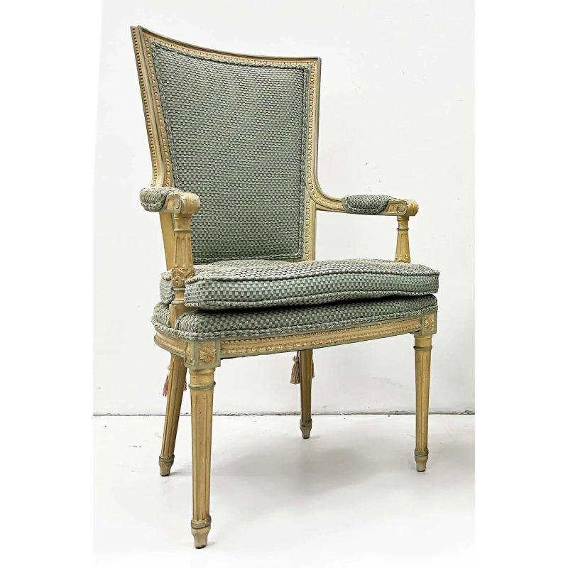 An ornate Louis XVI style armchair with a gilded hand-carved wood frame and sage green checkered fabric upholstery against a white background.