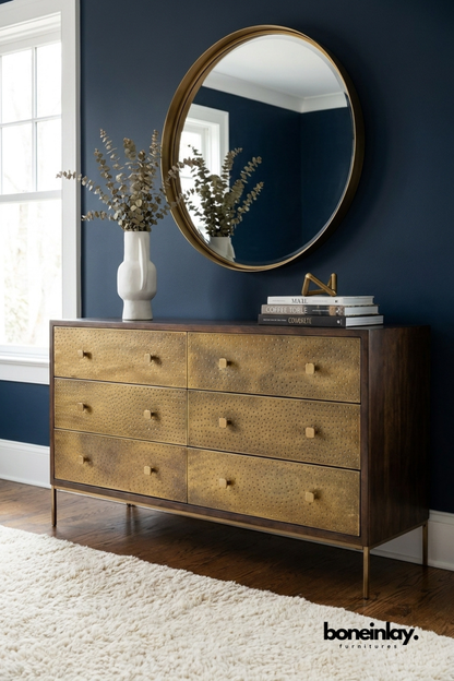 Handcrafted brass embossed six drawer dresser with textured metal drawer fronts, solid wood frame, slim brass legs, and luxurious bedroom storage cabinet.