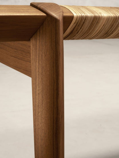 Minimalist rattan cane bench with solid wood structure, subtle curves, and handcrafted woven detailing.
