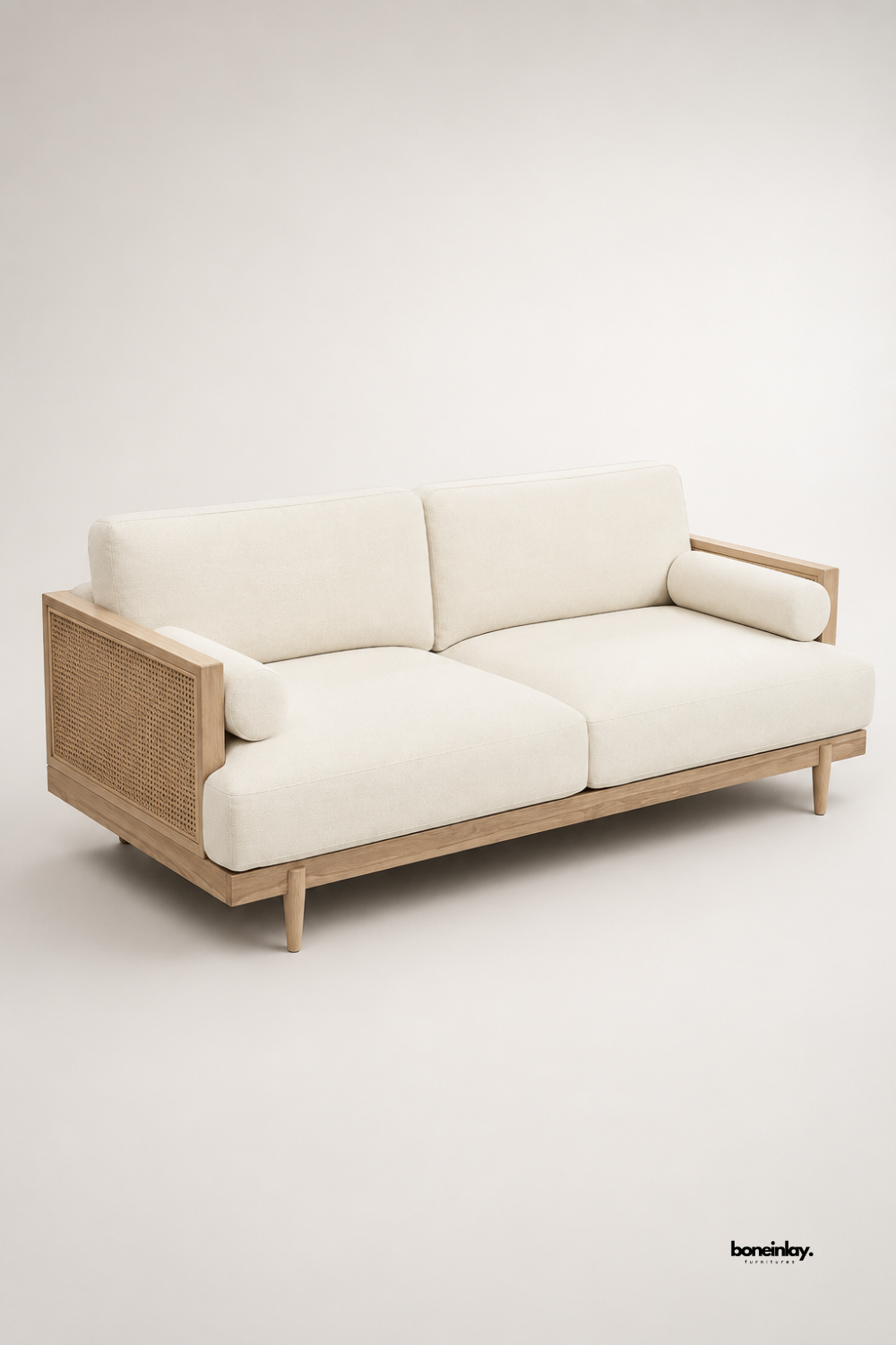 Artisan-crafted light wood 3-seater sofa showcasing woven cane webbing armrests, tapered wooden legs, and thick off-white seat cushions. Displayed against a clean studio background, this mid-century modern couch combines sustainable natural materials with plush comfort for living room spaces.