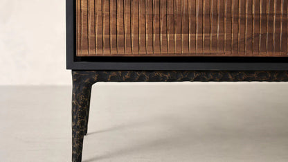 Modern dark wood sideboard with three textured doors and contrasting black metal accents.