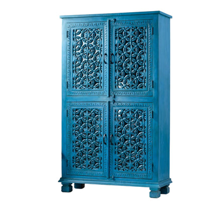 Moroccan style storage cabinet in teal wood, front view at an angle showing floral carved doors and the right side.
