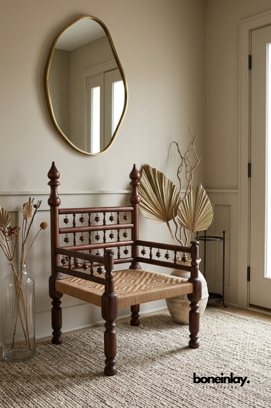 Traditional handcrafted wooden armchair with woven cane seat, spindle backrest, and turned wood legs for rustic or vintage inspired interiors.