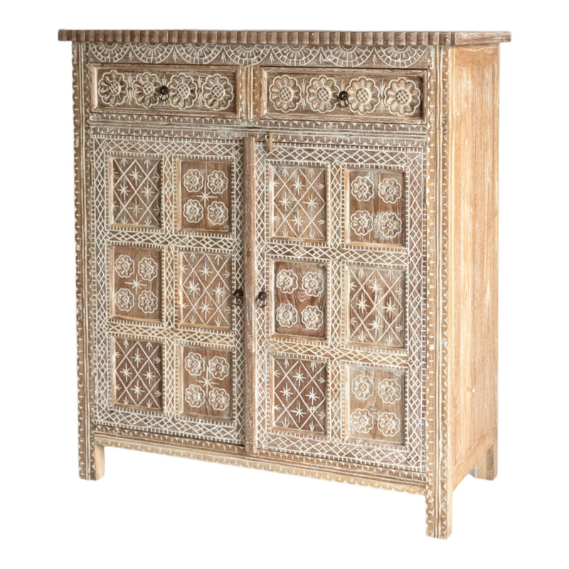 Natural wood accent cabinet with carved floral panels, shown in a front view from an angle that reveals its depth and slim legs.
