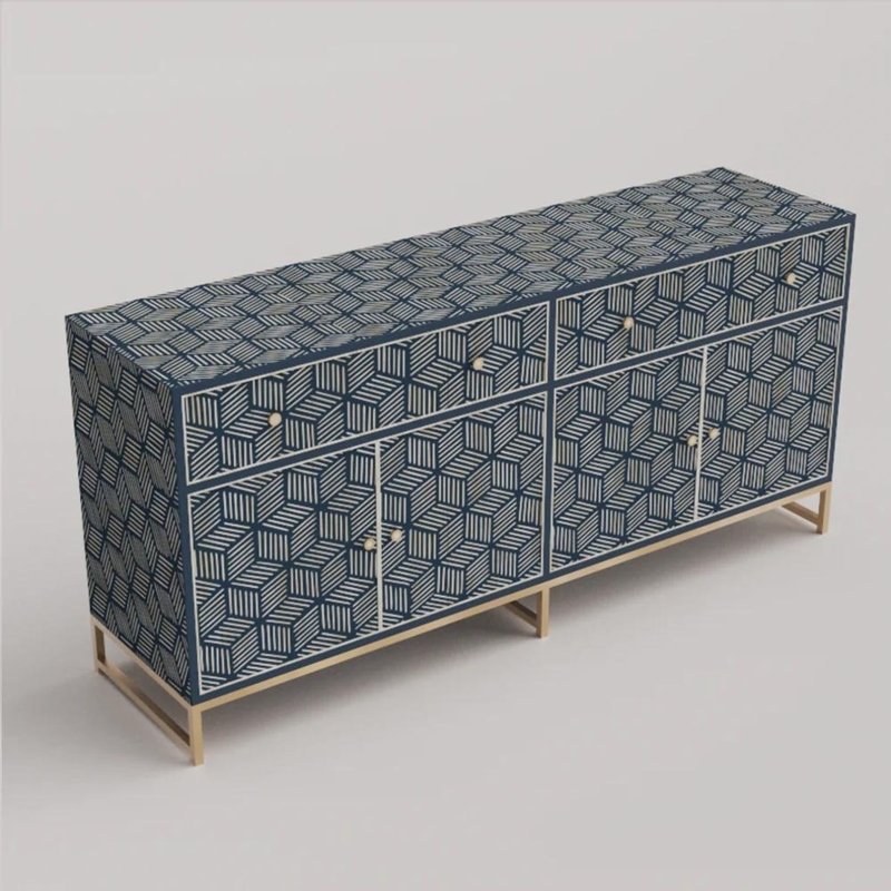 Three-quarter view of large navy blue bone inlay credenza with geometric cube stripe pattern covering top, front drawers, cabinet doors, and gold brass metal legs, handmade from solid mango wood.