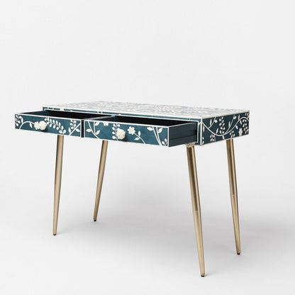 Navy blue bone inlay vanity desk with white floral vine pattern, two drawers with carved bone flower pulls, and brass hairpin legs
