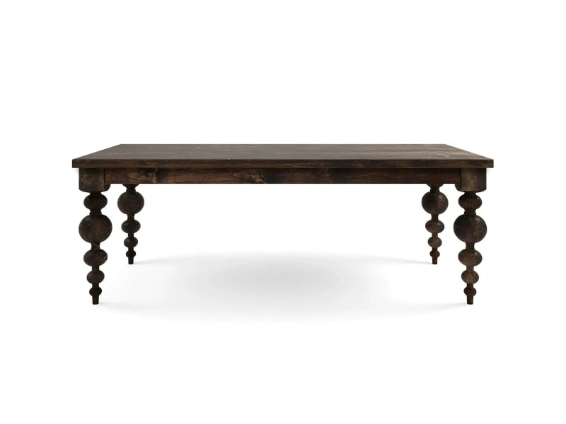 A luxury hand-carved solid wood dining table in a dark espresso finish featuring large sculptural orb-and-spindle turned legs.