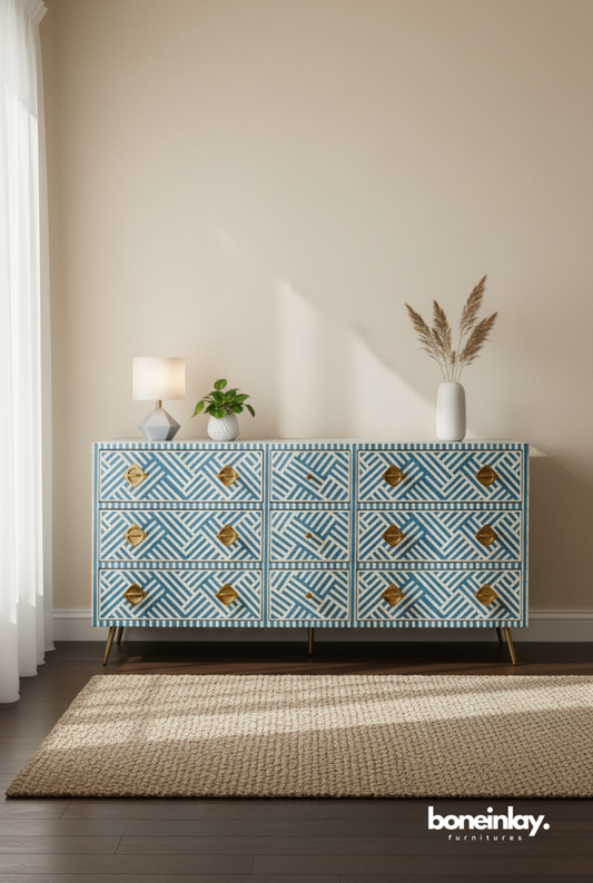 A modern sky blue and white striped bone inlay nine-drawer dresser. The piece features a high-contrast geometric pattern, bold sculptural gold-toned hardware, and minimalist metal legs. Shown in a bright, contemporary interior, this artisanal storage cabinet blends traditional Indian craftsmanship with a fresh, linear aesthetic.