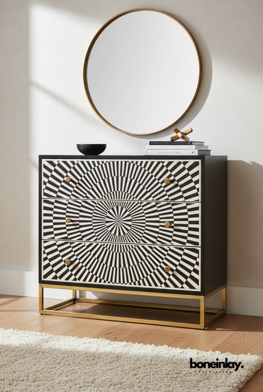 Handmade black and white optical illusion bone inlay 3-drawer dresser styled in a bright bedroom with gold metal base frame and round mirror above