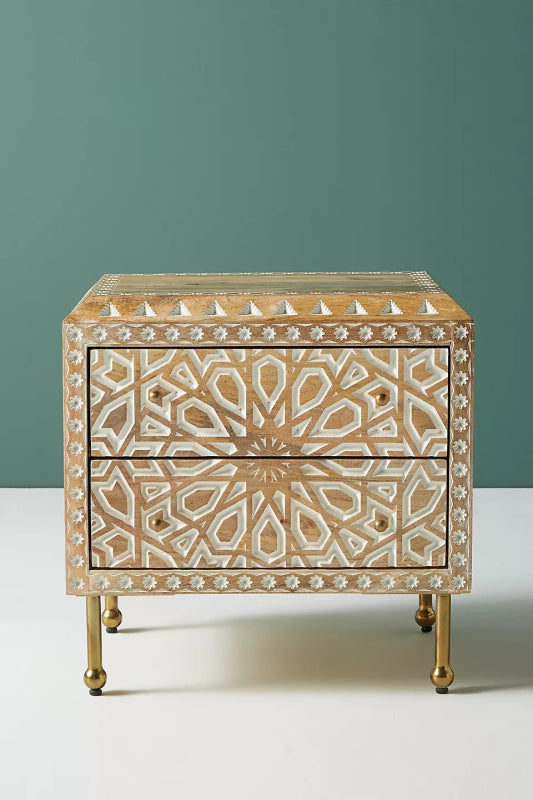 Ornate Carved Wood Commode with brass legs, shown straight on against a teal studio backdrop with both drawers closed.