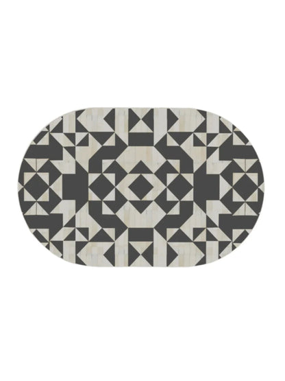 Overhead view of oval bone inlay coffee table top with symmetrical black white geometric inlay pattern luxury artisan furniture