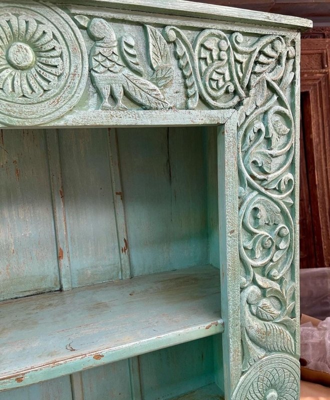 Peacock Carved Display Shelving in rustic solid wood, corner detail view showing birds, floral scrolls and worn edges.