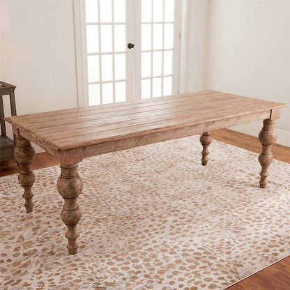 Handcrafted solid wood rectangular dining table with turned baluster spindle legs and plank tabletop in natural weathered finish.