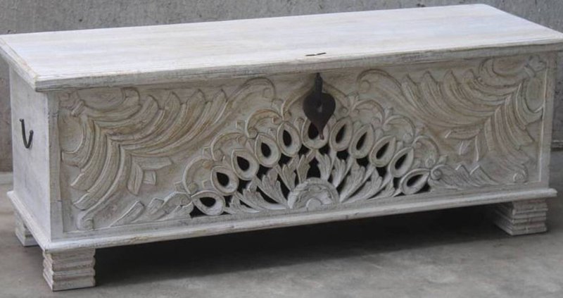 Rectangular wood blanket chest in a rustic finish, front view showing the left side handle, carved birds and closed lid.