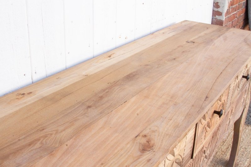 Rectangular Wood Hallway Table in rustic solid wood, top view showing long grain lines above the carved drawer fronts.