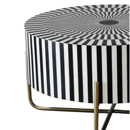 Luxury round bone inlay coffee table with an optical illusion striped inlay surface in black and white, featuring an antique brass cross-leg metal base