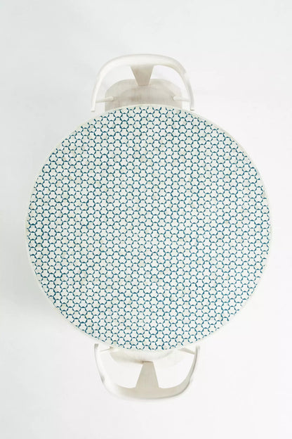 Overhead view of round teal bone inlay dining table showing full geometric surface pattern with white chairs around it